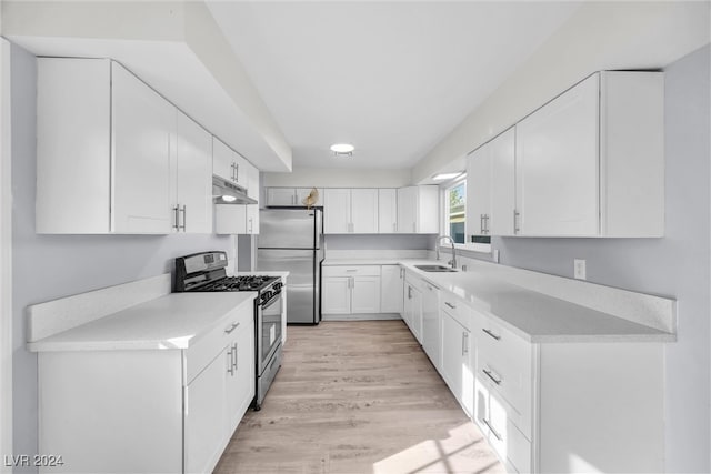 kitchen featuring sink, white cabinetry, stainless steel appliances, and light hardwood / wood-style flooring