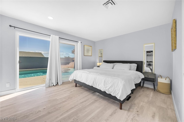 bedroom with access to outside and light hardwood / wood-style flooring