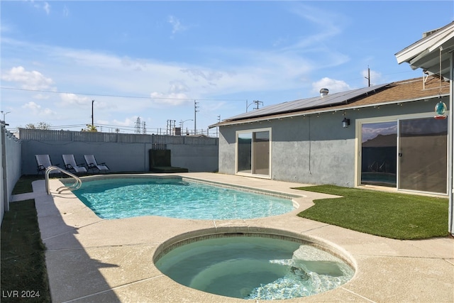 view of swimming pool featuring an in ground hot tub