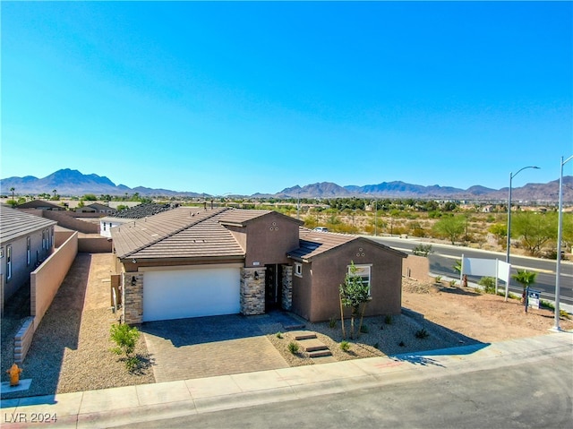 view of front of property featuring a mountain view and a garage