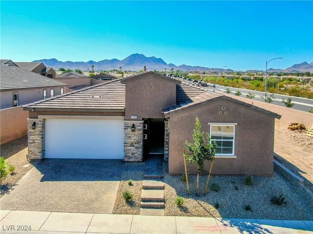 view of front of property with a mountain view and a garage