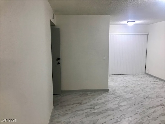 empty room featuring a textured ceiling