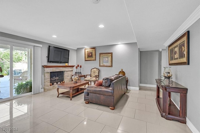 living room with a stone fireplace, ornamental molding, and light tile patterned floors