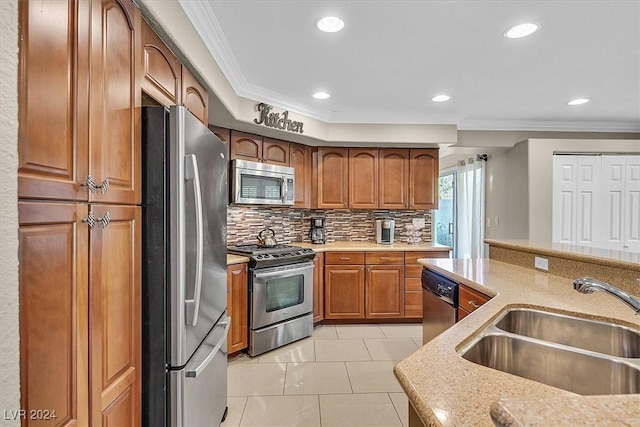 kitchen featuring crown molding, sink, tasteful backsplash, light stone counters, and stainless steel appliances