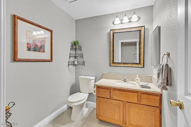 bathroom with tile patterned flooring, vanity, and toilet