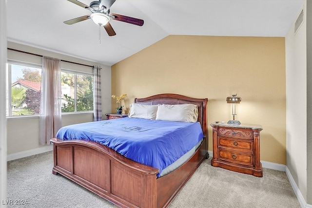 bedroom featuring ceiling fan, lofted ceiling, and light carpet