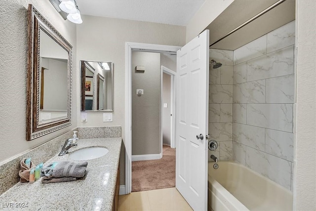 bathroom with a textured ceiling, tile patterned flooring, vanity, and tiled shower / bath combo