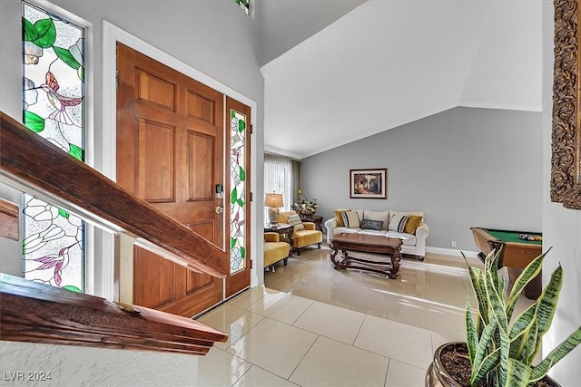 entryway with lofted ceiling, light tile patterned floors, and pool table