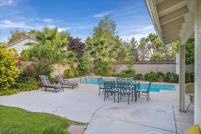 view of patio with a fenced in pool