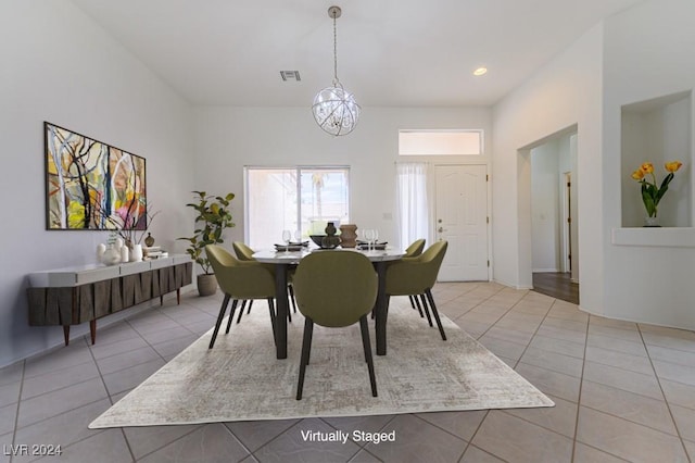 tiled dining area featuring a notable chandelier