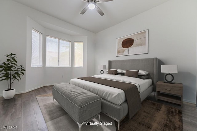 bedroom featuring vaulted ceiling, dark wood-type flooring, and ceiling fan