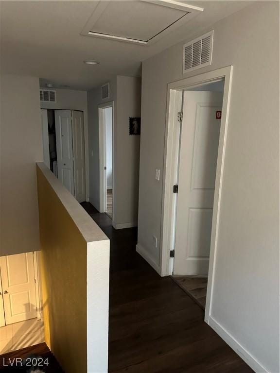 corridor with dark hardwood / wood-style flooring