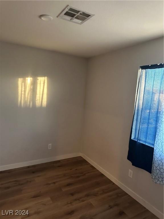 spare room with dark wood-type flooring