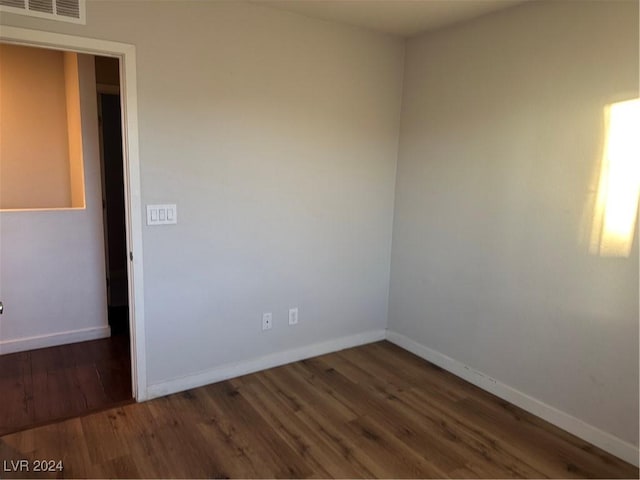 unfurnished room with dark hardwood / wood-style floors