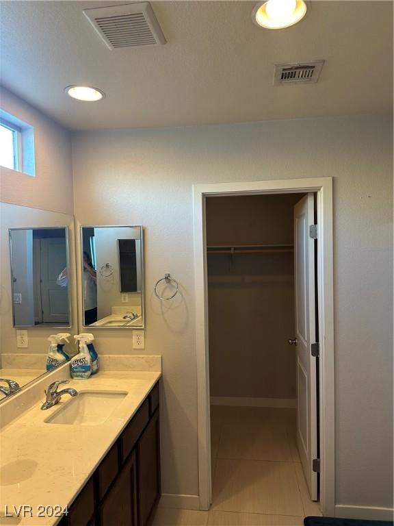 bathroom with tile patterned floors and vanity