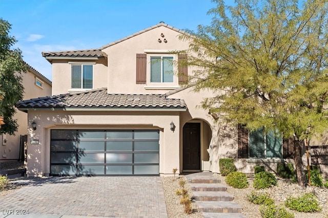 mediterranean / spanish house featuring a garage