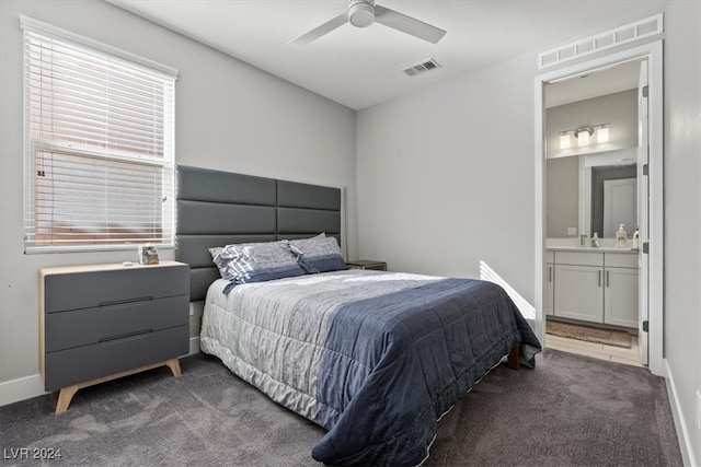 carpeted bedroom featuring ensuite bath and ceiling fan