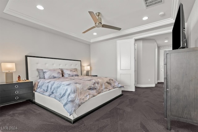 carpeted bedroom with a raised ceiling, ceiling fan, and ornamental molding