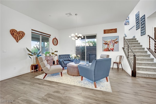 living room featuring a chandelier and wood-type flooring