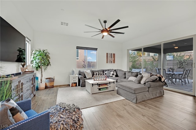 living room with ceiling fan and light wood-type flooring