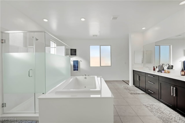 bathroom with tile patterned floors, vanity, and shower with separate bathtub