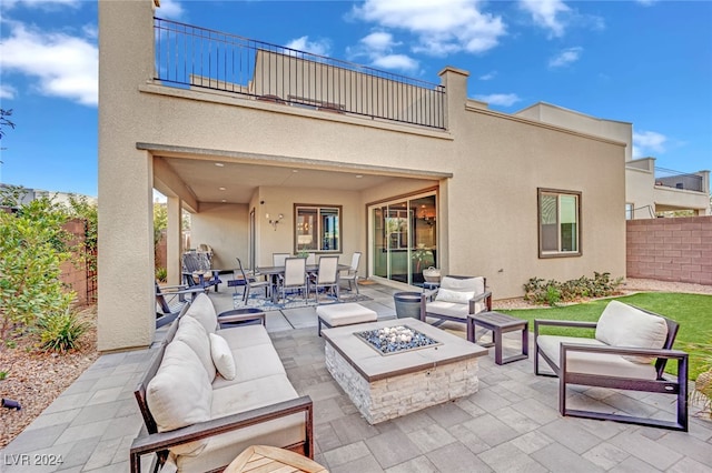 view of patio featuring an outdoor living space with a fire pit