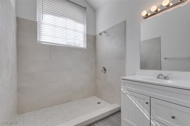 bathroom featuring vanity and tiled shower