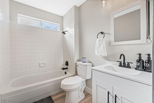 full bathroom featuring hardwood / wood-style floors, vanity, toilet, and tiled shower / bath