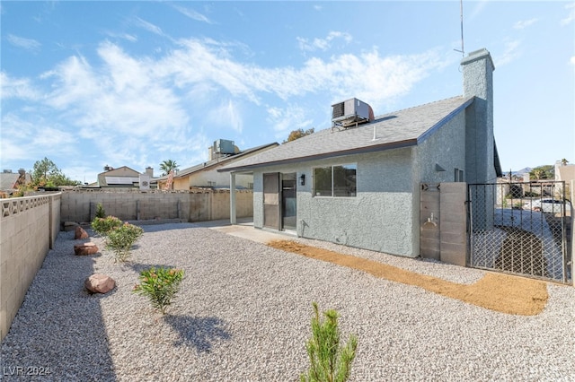 rear view of house featuring cooling unit