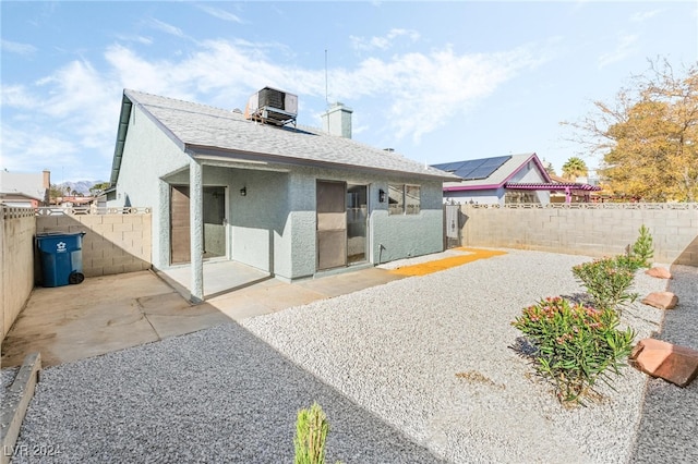 rear view of property featuring cooling unit and a patio