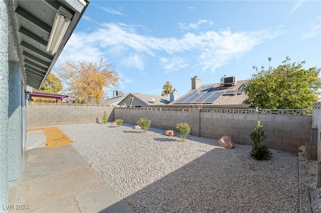 view of yard featuring central AC unit and a patio area