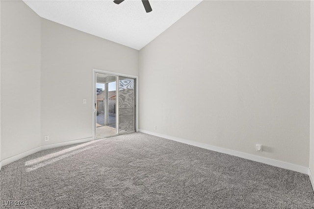 carpeted empty room with ceiling fan and vaulted ceiling