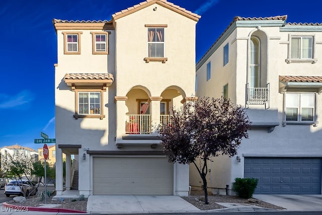 mediterranean / spanish-style home featuring a balcony and a garage