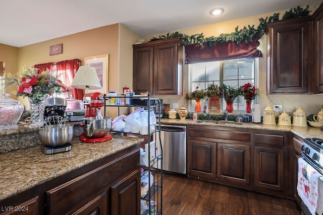 kitchen featuring dishwasher, sink, dark hardwood / wood-style floors, white gas range, and dark brown cabinetry