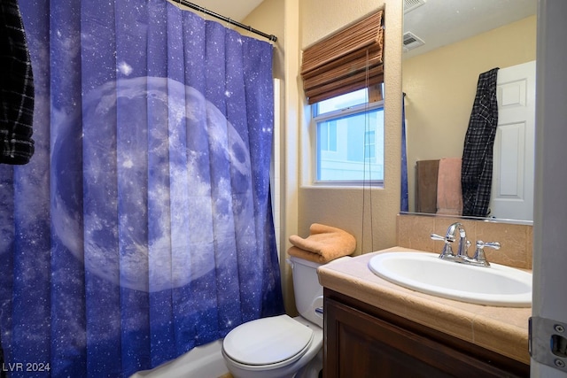 full bathroom with vanity, shower / bath combination with curtain, and toilet