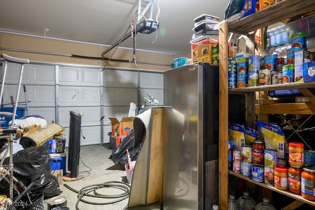 garage featuring a garage door opener and stainless steel refrigerator