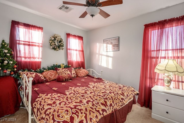 bedroom featuring ceiling fan and light carpet