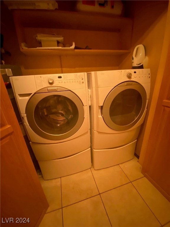 laundry room featuring tile patterned floors and washing machine and dryer