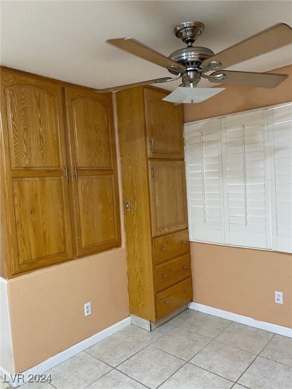 unfurnished bedroom with light tile patterned floors and ceiling fan