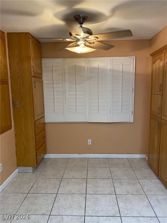 unfurnished bedroom featuring ceiling fan and light tile patterned floors