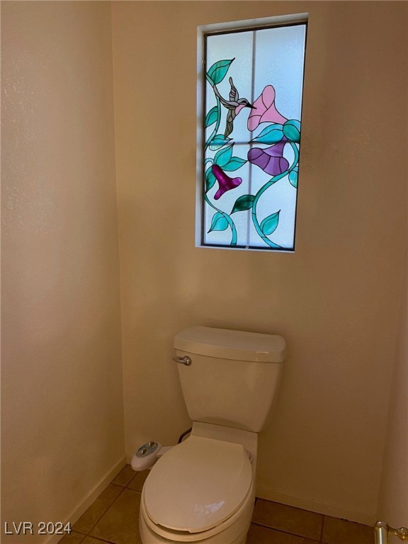 bathroom featuring toilet and tile patterned floors