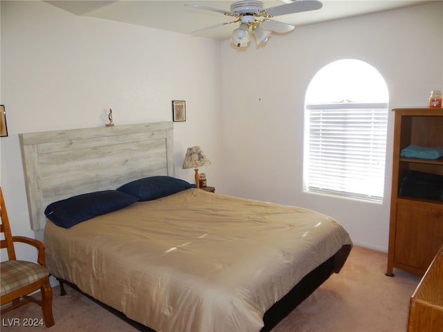 bedroom with ceiling fan and light carpet