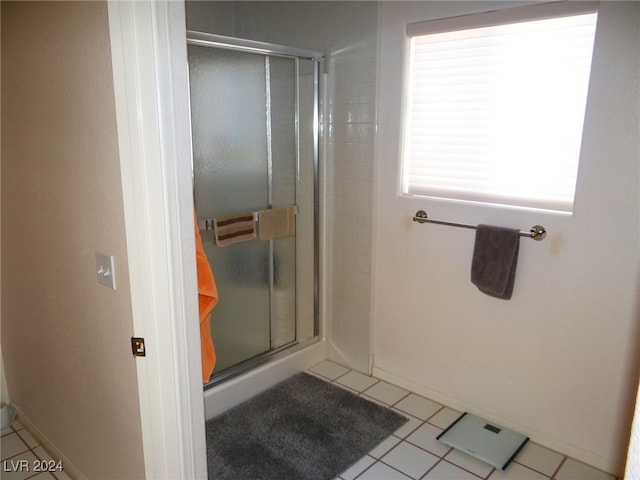 bathroom with tile patterned flooring and a shower with shower door