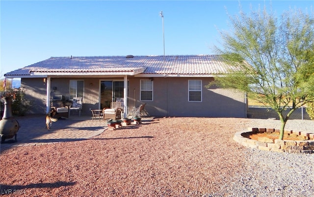 rear view of property featuring a patio