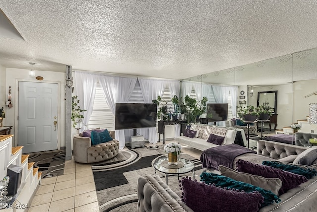 living room with light tile patterned flooring, a healthy amount of sunlight, and a textured ceiling