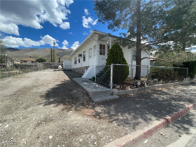 view of property exterior featuring a mountain view