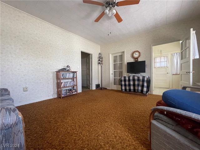 living room with ceiling fan and ornamental molding