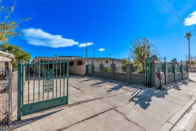 view of gate with a fenced front yard