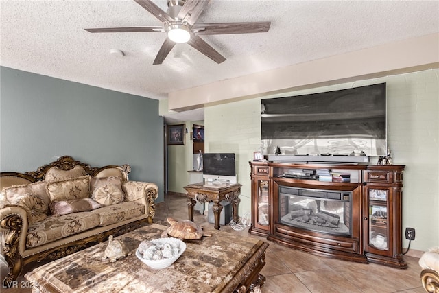 tiled living area featuring ceiling fan and a textured ceiling