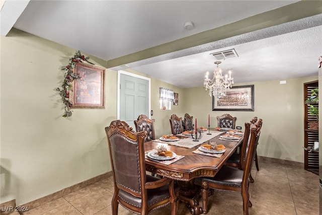 dining room featuring light tile patterned floors, visible vents, and baseboards